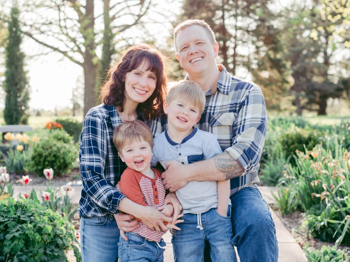 amy and gabe outside in a family photo with their two sons