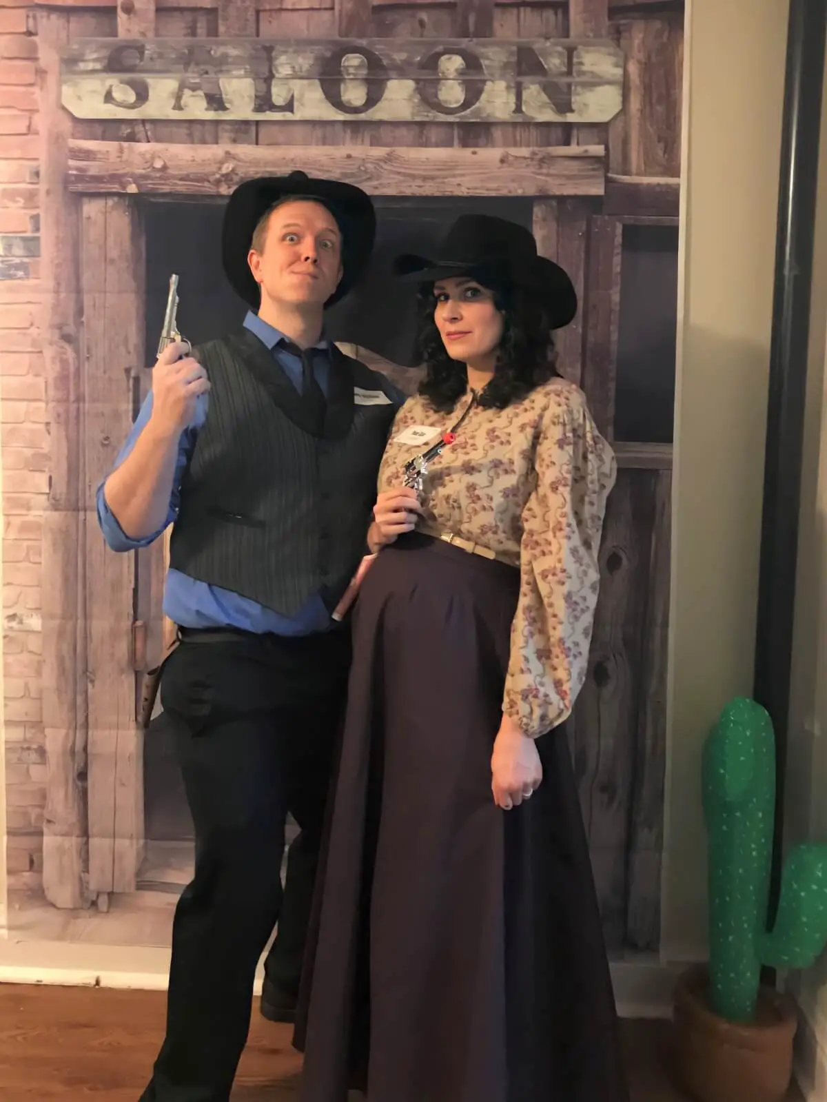 Gabe and Amy in Western costumes with a "Saloon" backdrop