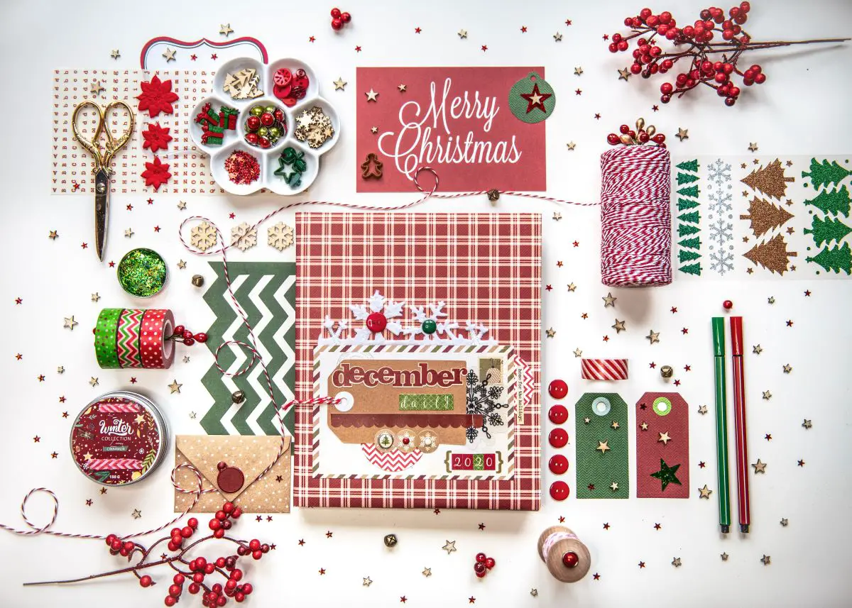Christmas scrapbook supplies on a table.