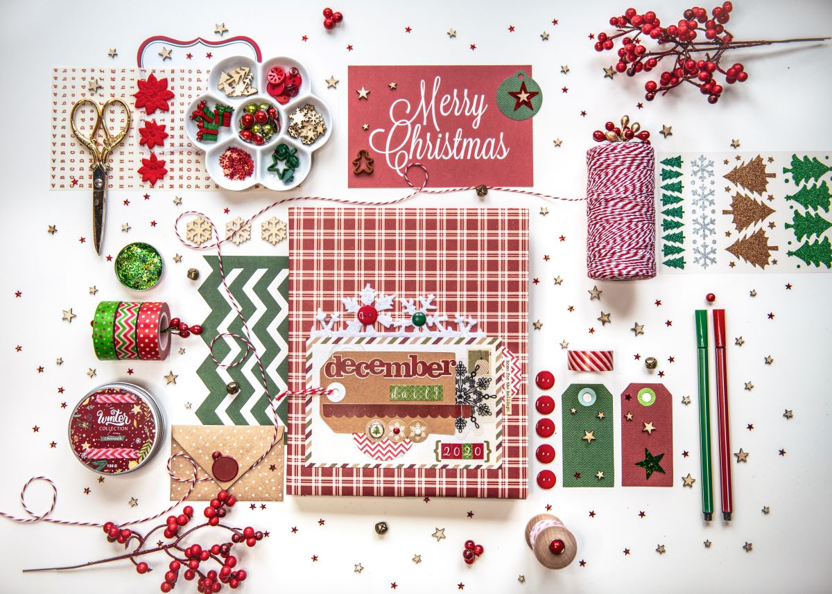 Christmas scrapbook supplies on a table.