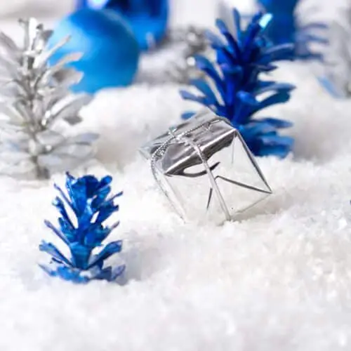 Silver and Blue Christmas decorations on fake snow for a Winter Wonderland Christmas Party Theme.