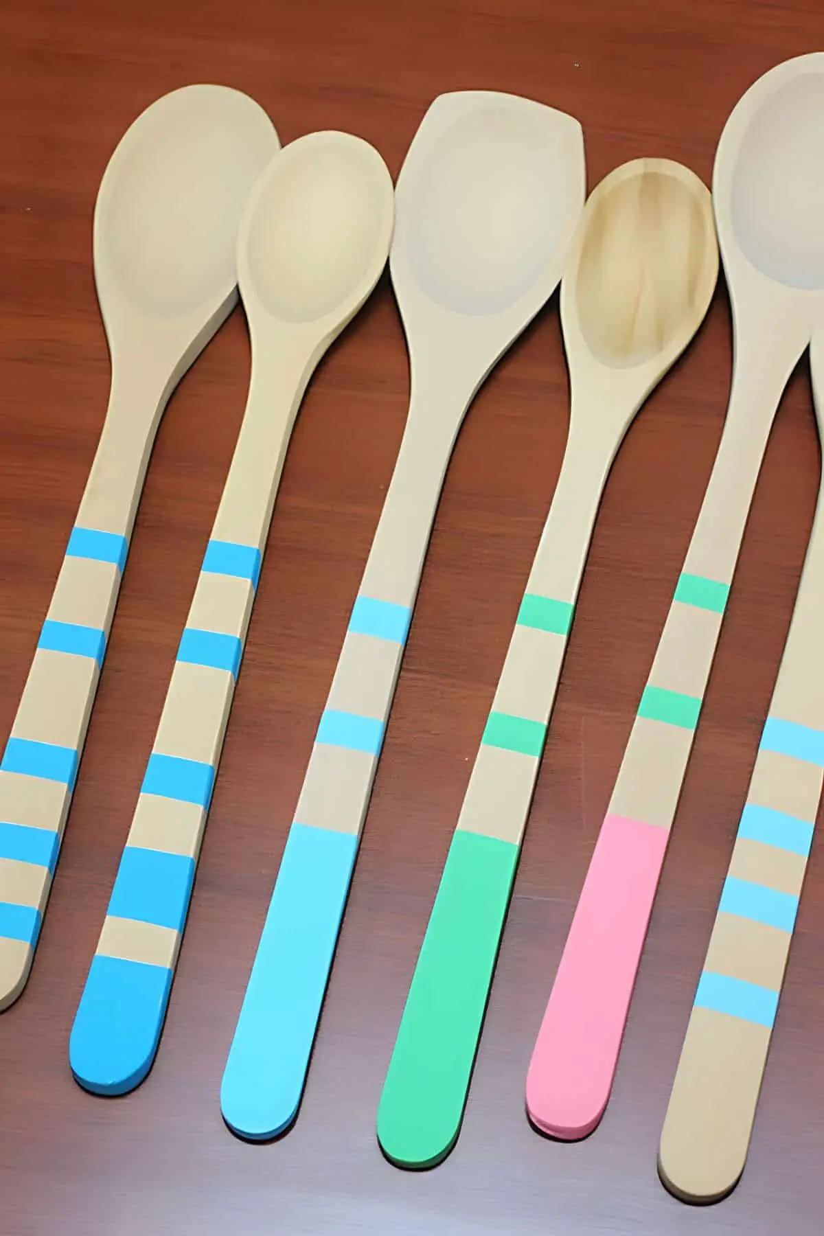 Wooden spoons that have been hand painted on the handles.
