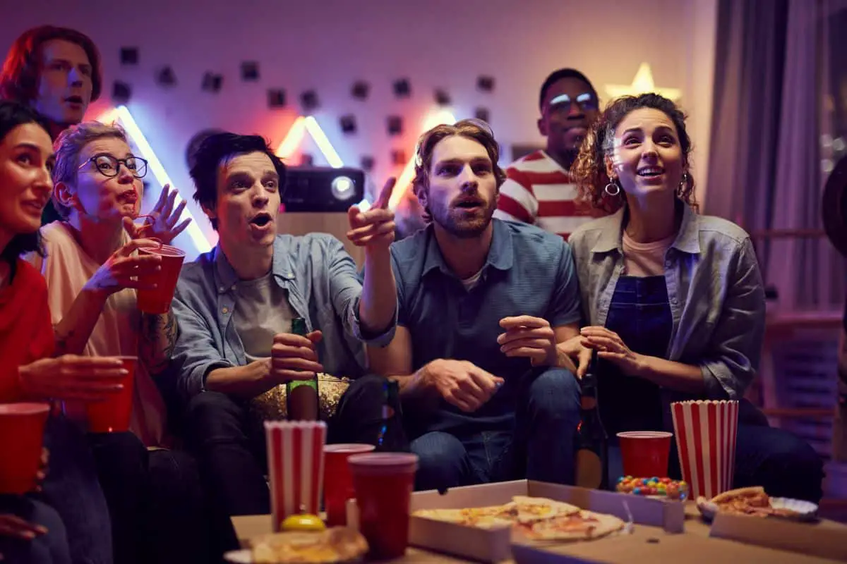 Friends with popcorn at a movie party.